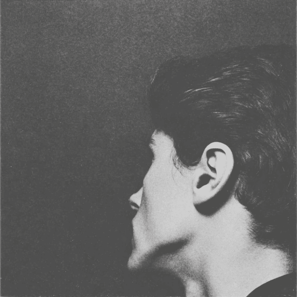 Black-and-white close-up portrait in profile, showing the ear